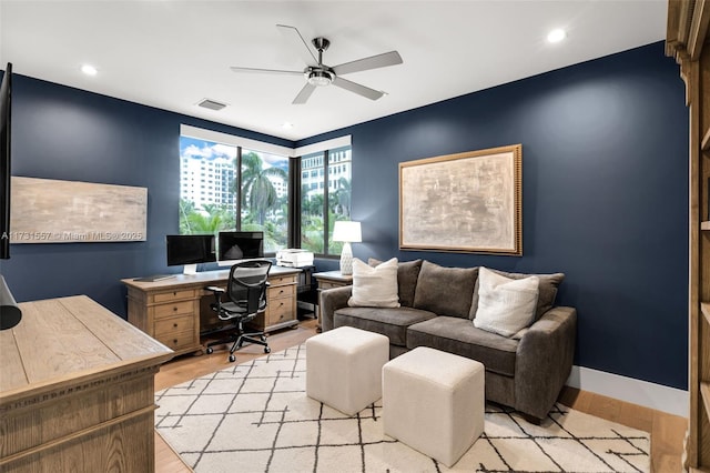 office space with ceiling fan and light wood-type flooring