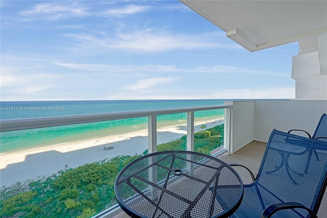 balcony with a water view and a beach view