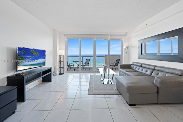 living room featuring floor to ceiling windows and a textured ceiling