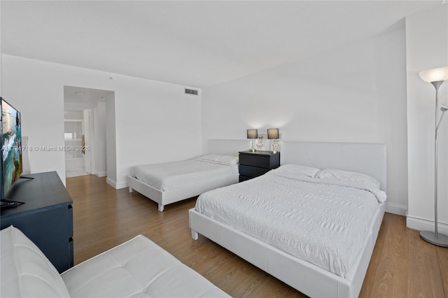 bedroom with hardwood / wood-style floors