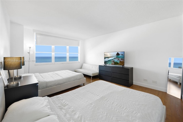 bedroom with dark wood-type flooring