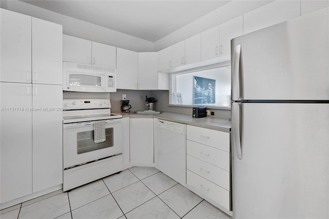 kitchen featuring white cabinets and white appliances