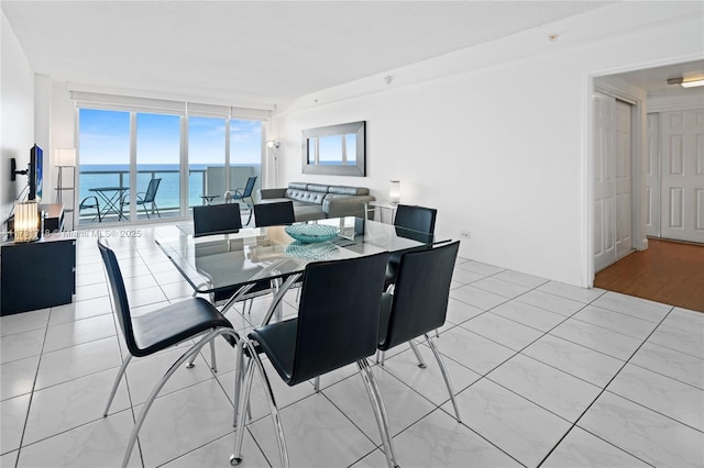 dining space featuring floor to ceiling windows