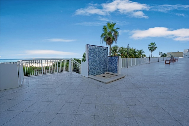 view of patio with a water view