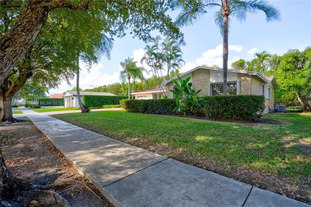 single story home with a garage and a front yard