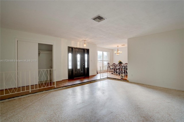 entryway featuring an inviting chandelier