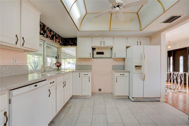 kitchen with sink, white cabinetry, ceiling fan, a tray ceiling, and white appliances