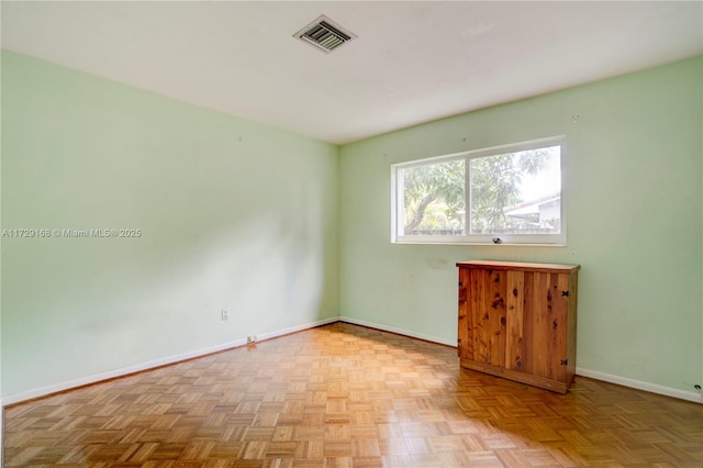 unfurnished room with light parquet floors