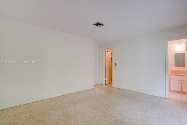 unfurnished room featuring sink