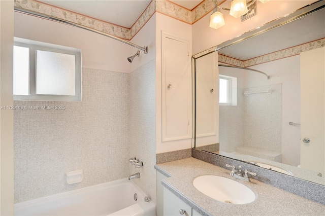 bathroom featuring vanity and tiled shower / bath