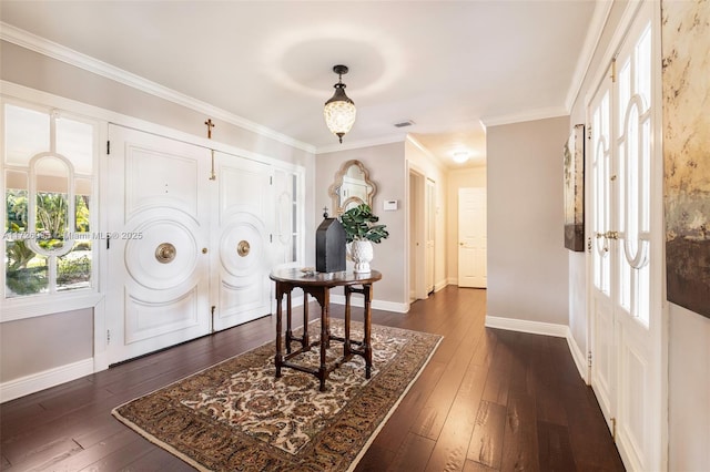 foyer entrance featuring ornamental molding and dark hardwood / wood-style floors