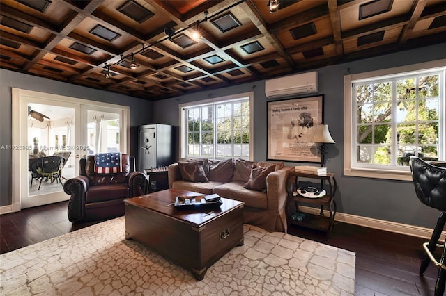 living room featuring dark wood-type flooring, french doors, coffered ceiling, an AC wall unit, and beam ceiling