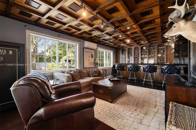 living room with hardwood / wood-style flooring, a wall mounted AC, coffered ceiling, bar area, and beamed ceiling