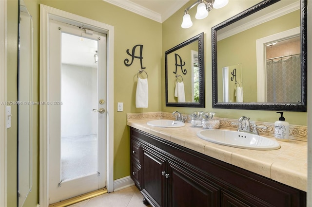 bathroom featuring tile patterned flooring, ornamental molding, and vanity