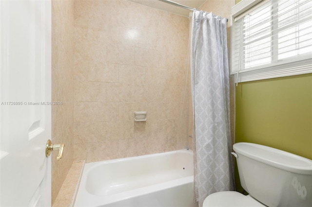 bathroom featuring toilet and shower / bath combo with shower curtain