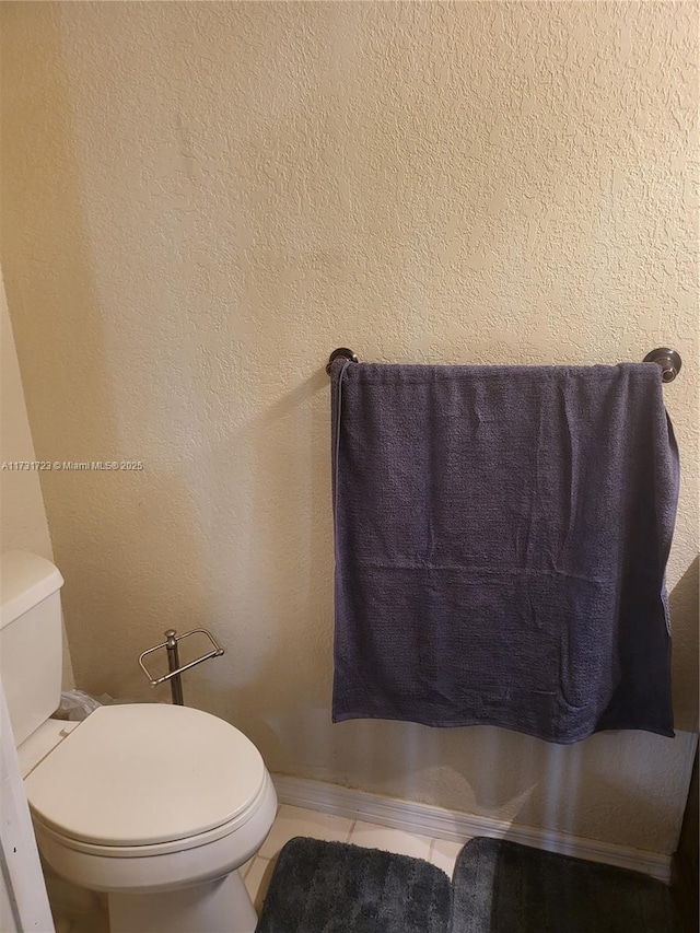 bathroom featuring tile patterned flooring and toilet