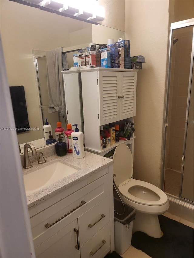 bathroom featuring vanity, toilet, and walk in shower