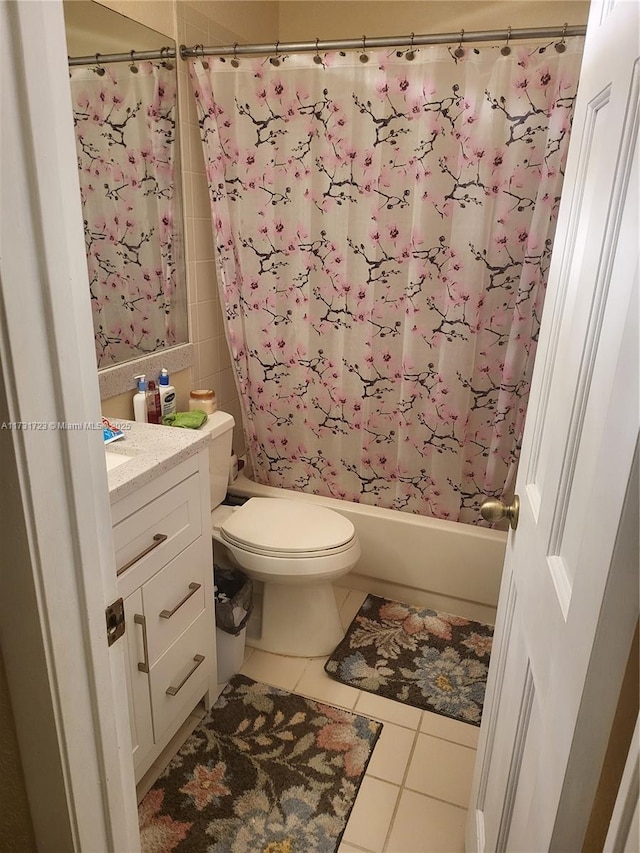 full bathroom featuring tile patterned flooring, vanity, shower / bath combo, and toilet