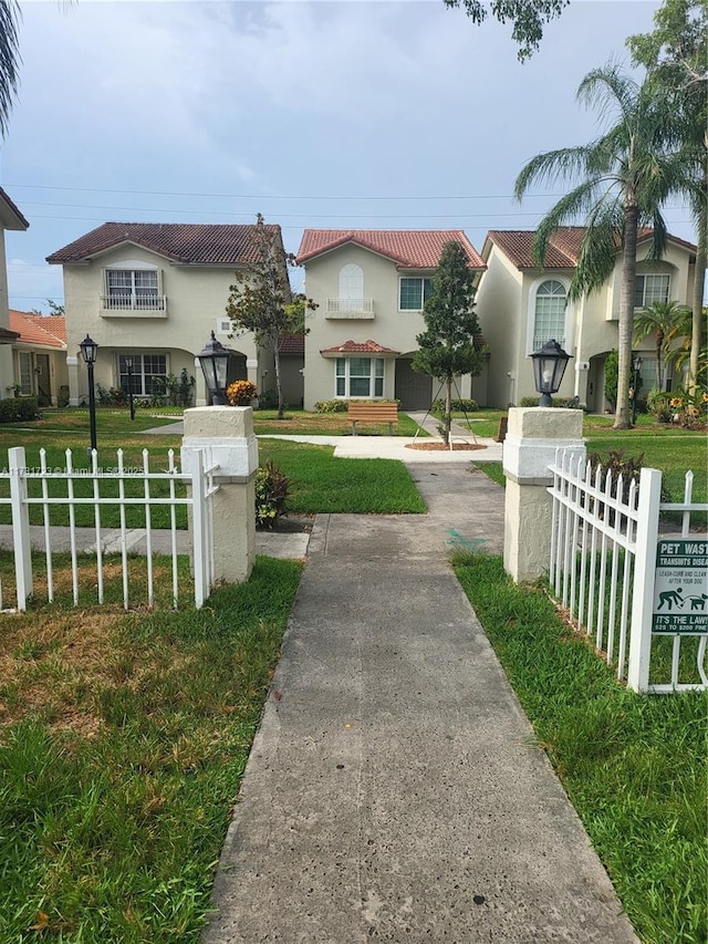 mediterranean / spanish-style home with a front lawn