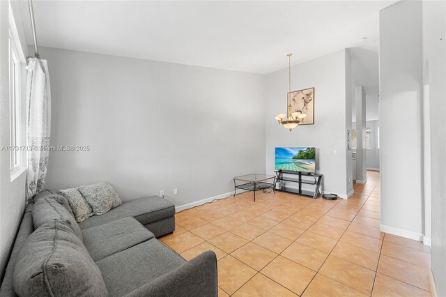 living room featuring lofted ceiling and light tile patterned flooring