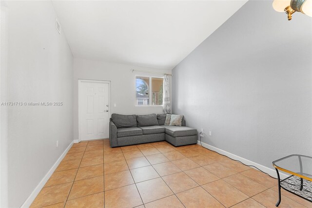 tiled living room featuring lofted ceiling