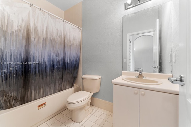 bathroom featuring a textured wall, toilet, vanity, tile patterned floors, and shower / bath combo with shower curtain