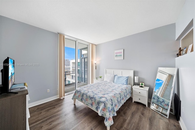 bedroom with expansive windows, access to exterior, and dark wood-type flooring