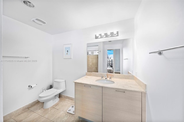 bathroom with vanity, tile patterned floors, and toilet