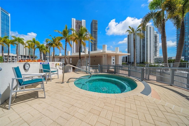 view of swimming pool featuring a community hot tub and a patio area