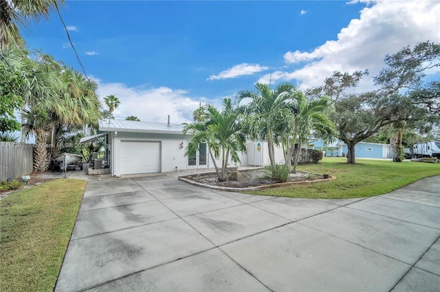 single story home featuring a garage and a front yard