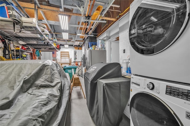 laundry room featuring stacked washer / drying machine