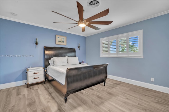 bedroom featuring ornamental molding, ceiling fan, and light hardwood / wood-style flooring