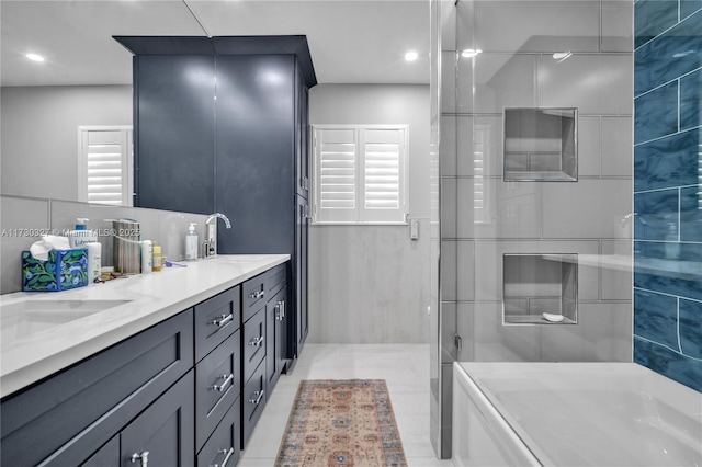 bathroom featuring vanity and an enclosed shower