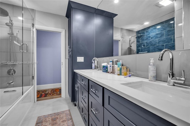 bathroom with enclosed tub / shower combo, vanity, and tile patterned flooring