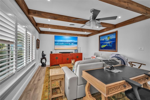 living room with ceiling fan, beam ceiling, and hardwood / wood-style floors