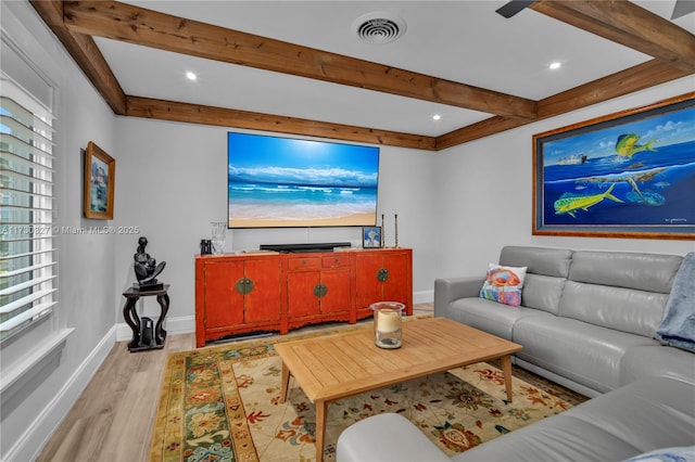 living room with beam ceiling and light hardwood / wood-style flooring