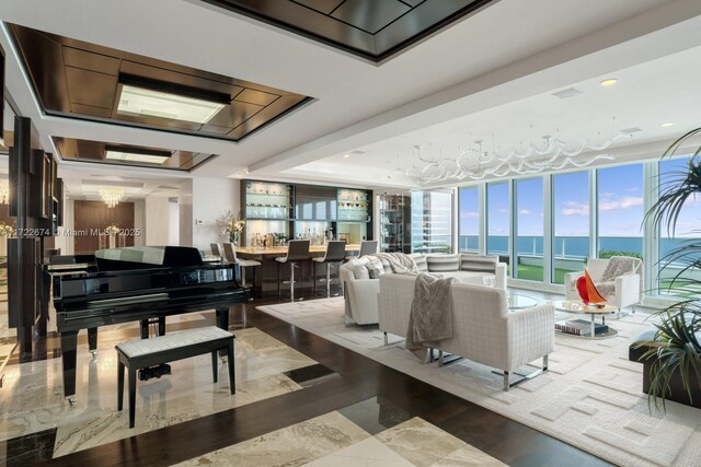 game room featuring a water view, plenty of natural light, dark hardwood / wood-style flooring, and billiards