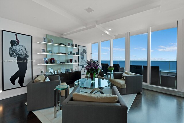 living room featuring a water view, expansive windows, and hardwood / wood-style floors