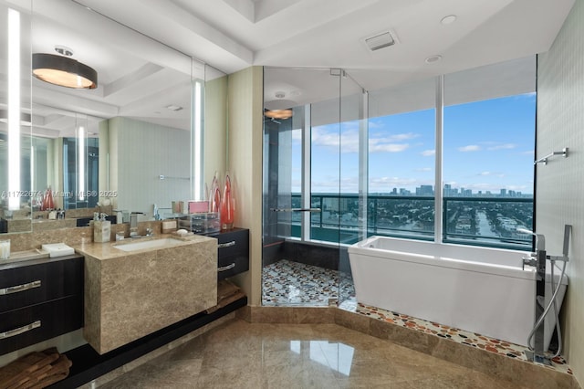 bathroom with a shower stall, a city view, a soaking tub, vanity, and a raised ceiling