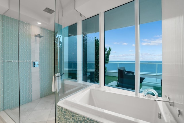 bathroom featuring tile patterned flooring, a garden tub, and a walk in shower