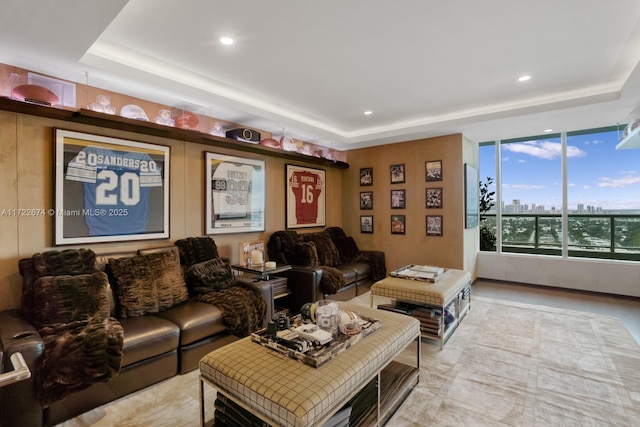 living area with a city view, a raised ceiling, and recessed lighting