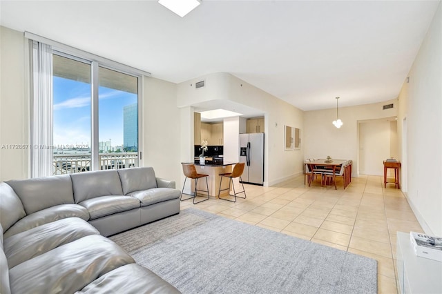 tiled living room with floor to ceiling windows