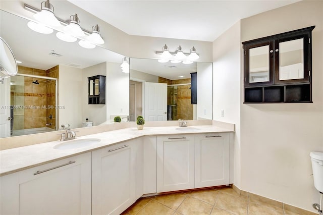 full bathroom featuring tile patterned flooring, vanity, bath / shower combo with glass door, and toilet