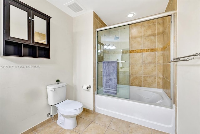 bathroom with tile patterned floors, toilet, and combined bath / shower with glass door