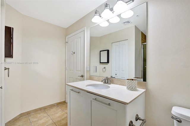 bathroom with vanity, tile patterned floors, and toilet