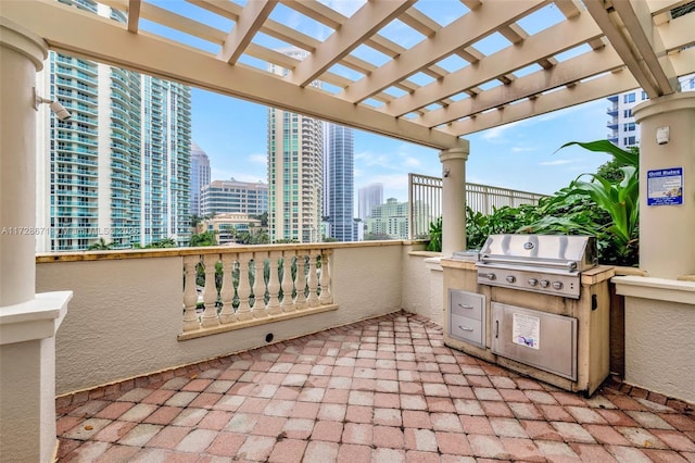 view of patio / terrace with exterior kitchen, area for grilling, and a pergola