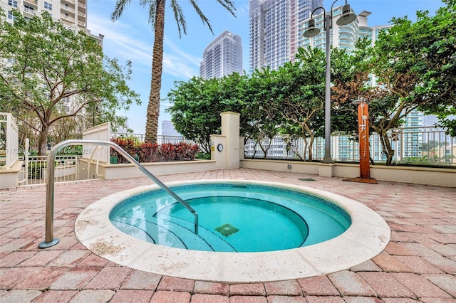 view of pool with a hot tub and a patio area