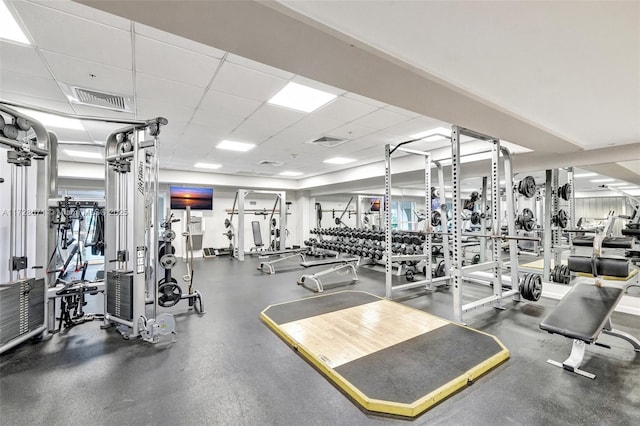 exercise room with a paneled ceiling