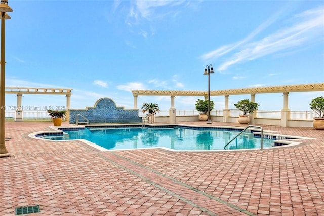 view of swimming pool featuring a patio area and a pergola