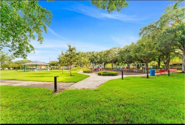 view of home's community featuring a yard, a gazebo, and a playground